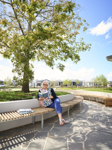 Lifestyle Communities Mount Duneed Lady reading under oak tree