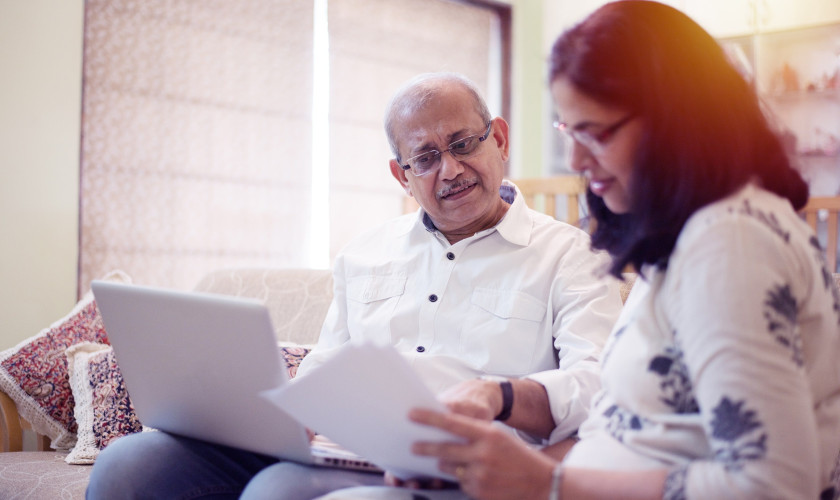 Indian couple laptop learning computer research min